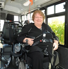 Photo of an adapted transportation client with seatbelt
